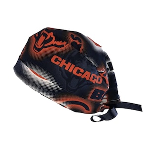 May include: A blue and orange surgical scrub hat with a white and black polka dot pattern. The hat features the Chicago Bears logo and the text "CHICAGO BEARS".