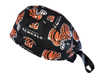 May include: Black and orange surgical scrub hat with a repeating pattern of Cincinnati Bengals logos and helmets.