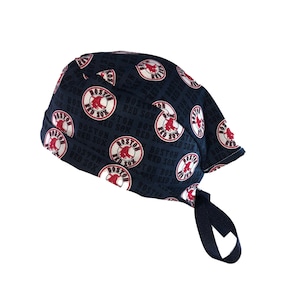 May include: A navy blue surgical scrub hat with a repeating pattern of the Boston Red Sox logo. The logo features a red bull with the words "Boston Red Sox" in black text.