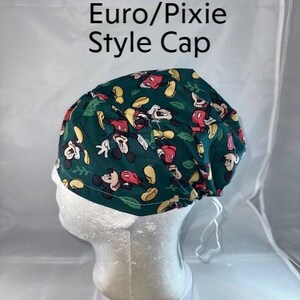 a white mannequin head with a green hat on top of it