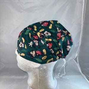 a green hat with mickey mouses on it