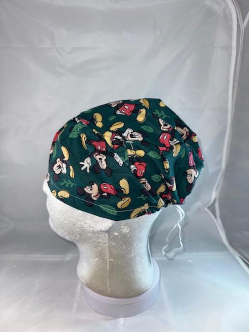a green hat with mickey mouses on it