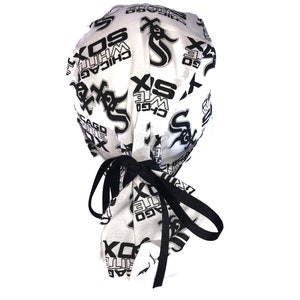 May include: White fabric surgical cap with black elastic ties. The cap is printed with a repeating pattern of the Chicago White Sox logo and the words "Chicago White Sox".