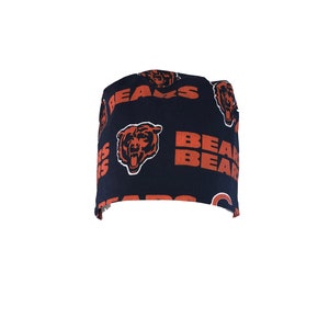 May include: A black scrub hat with a repeating pattern of orange "BEARS" text and bear head logos.