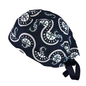 May include: A blue and green surgical scrub hat with a repeating pattern of the Seattle Mariners logo. The hat has a navy blue tie.