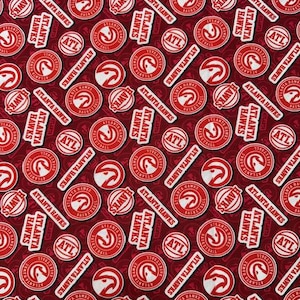 May include: Red fabric with a repeating pattern of white Atlanta Hawks logos, including the team's mascot, a basketball, and the letters ATL. The background is a deep red color.