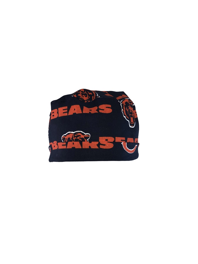 May include: Black beanie with a repeating pattern of orange bears and the word "BEARS" in orange.