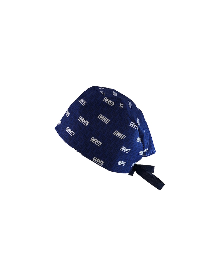 May include: A blue and white patterned surgical cap with a black tie. The cap has the word "Giants" repeated in a white pattern.