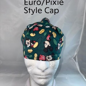 a white mannequin head wearing a green mickey mouse hat