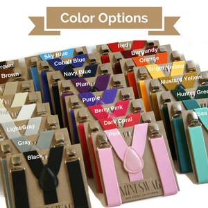 May include: A display of suspenders in various colors, including sky blue, red, and pink. Each pair is attached to a cardboard backing with silver-colored clips. The text "Color Options" is at the top.