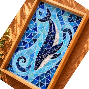 May include: A rectangular wooden tray featuring a mosaic design of a whale swimming through blue and light blue water. The whale is composed of dark blue and white tiles, while the surrounding water consists of various shades of blue glass.