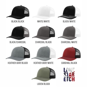 May include: A selection of trucker hats in various colours and combinations. The hats have a mesh back and a solid front panel. The colours include black, white, charcoal, heather grey, cardinal, and loden. Each hat is labelled with the colour combination of the front panel and the mesh back.
