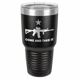 May include: Black stainless steel tumbler with a white silhouette of a rifle and a star, and the text "COME AND TAKE IT".
