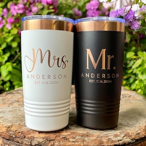 May include: Two stainless steel tumblers with copper lids. The white tumbler has "Mrs. Anderson EST. 11.16.2024" in gold lettering. The black tumbler has "Mr. Anderson EST. 11.16.2024" in gold lettering.