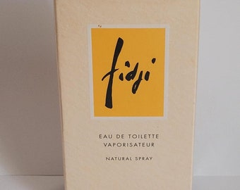 May include: A yellow and white box with the text "fidji" in black script. The box is for a 3.4 fl oz bottle of Eau de Toilette Vaporisateur Natural Spray by Guy Laroche Paris.