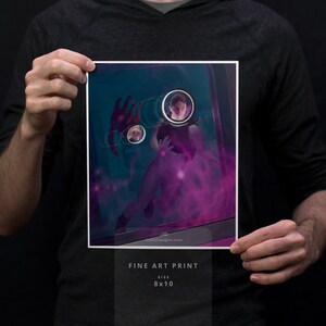 May include: A fine art print of a woman in a purple and blue nebula with a glowing orb around her head. The print is 8x10 inches.