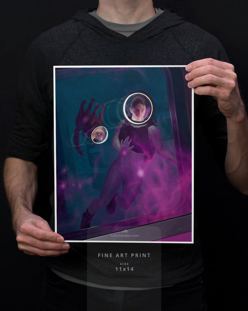 May include: A fine art print of a woman in a futuristic setting, surrounded by a purple glow. The woman is wearing a black jumpsuit and has a determined expression on her face. The print is 11x14 inches.