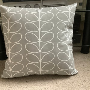 May include: A square cushion with a grey background and a white leaf design. The cushion is made of fabric and is intended for home decor. The cushion is approximately 45 cm square.
