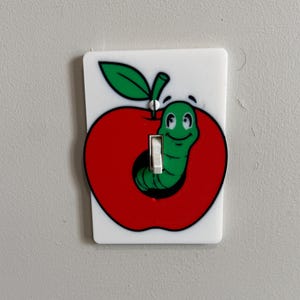 May include: A set of three ceramic mugs with a speckled, matte finish. The mugs are in shades of cream, light gray, and dark gray. Each mug has a simple, minimalist design, perfect for coffee or tea.