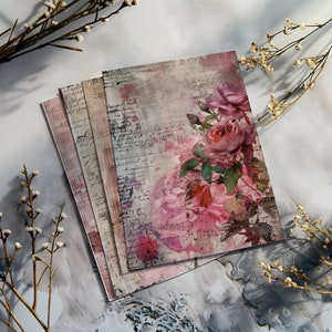 May include: A stack of vintage-style paper with a watercolor floral design featuring pink roses and a musical note background.