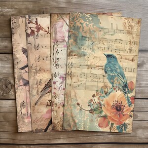 May include: Four vintage-style paper sheets with musical notes, floral designs, and birds. The sheets have a distressed, aged look with splashes of color. One sheet features a blue bird perched on a branch with a peach-colored flower.