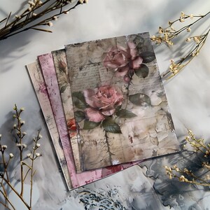 May include: A stack of vintage-style paper with a faded floral design. The paper features pink roses and handwritten text on a textured background.