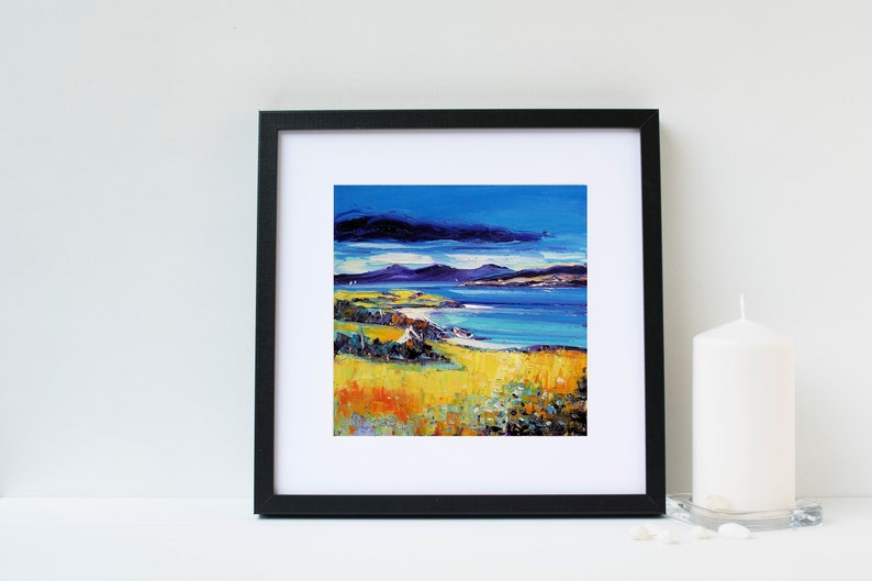 May include: Framed painting of a seascape with a blue sky, white clouds, and a yellow grassy field in the foreground. The painting is in a black frame.