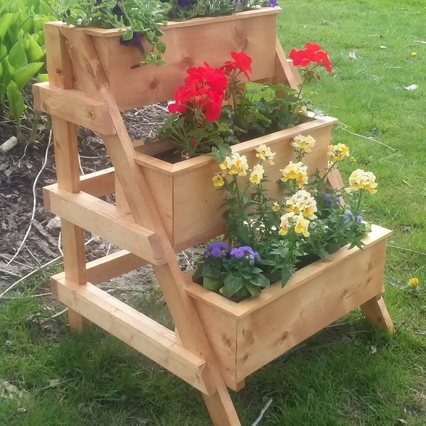 3 Tier planter stand with 3 planters.  Braced so that it will last for years.