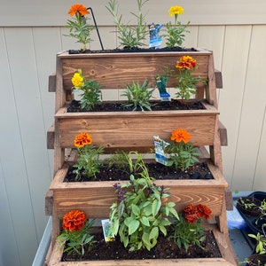 4 Tier planter stand with (4) planters on it.  We call this Early American Stain.  Braced so that it will last for years....
