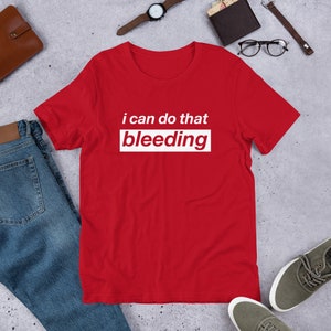 Peut inclure: T-shirt rouge à manches courtes avec du texte blanc qui dit "i can do that bleeding".