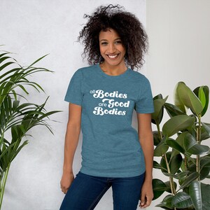 May include: A teal blue t-shirt with the text "all bodies are good bodies" in white retro font.