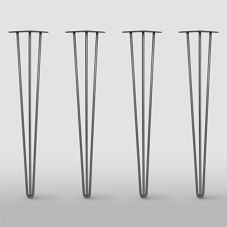 May include: Four black hairpin table legs. Each leg has three rods that taper to a point. The top of each leg has a flat, square mounting plate. The legs are evenly spaced against a white background.