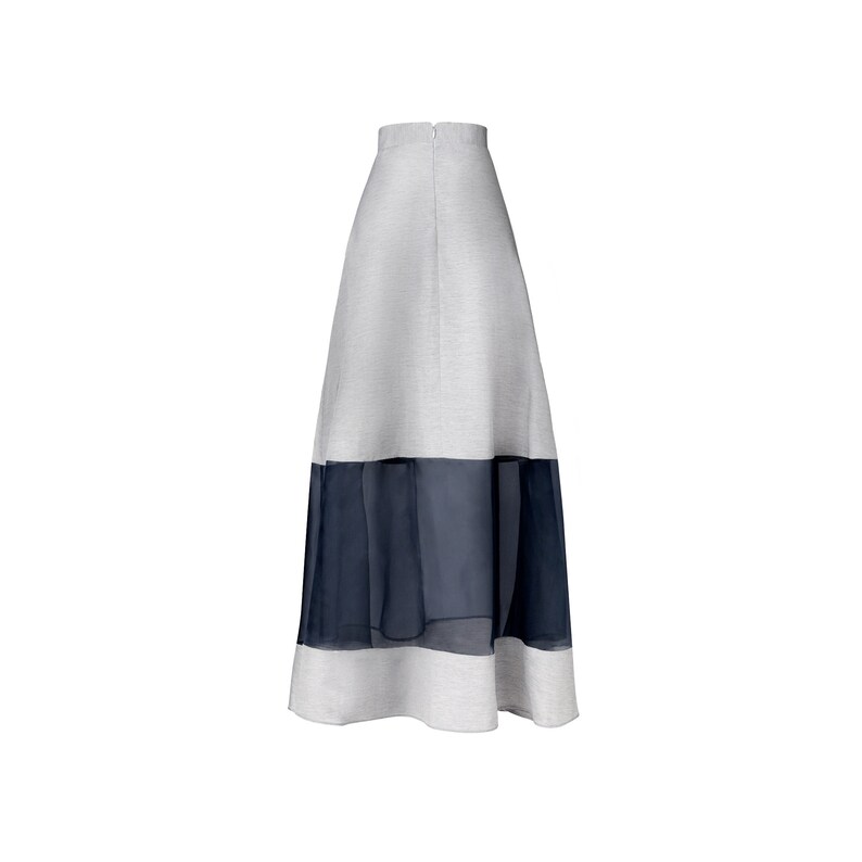 May include: A long gray skirt with a black sheer overlay at the bottom.