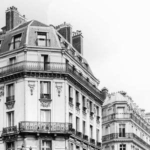 May include: Black and white photo of a Parisian building with a sign that reads "Hotel Normandy".