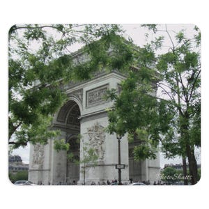 May include: A view of the Arc de Triomphe in Paris, France. The monument is made of white stone and is surrounded by trees. The archway is visible in the centre of the image.