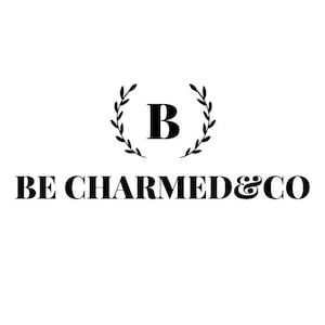 Peut inclure: Logo noir et blanc avec une couronne de laurier entourant la lettre "B" et le texte "BE CHARMED & CO."