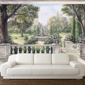 May include: A white couch sits in front of a mural depicting a garden scene with a fountain in the center. The mural features trees, flowers, and a stone walkway.