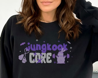 May include: Black sweatshirt with a purple graphic that says "jungkook CORE" with a cartoon bunny lifting weights.