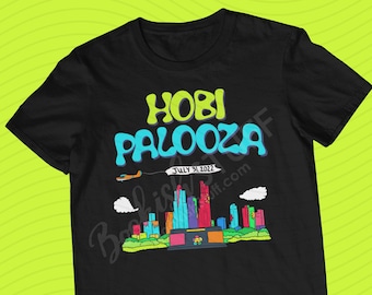 May include: Black t-shirt with a colorful graphic of a city skyline and the text "HOBI PALOOZA" with the date "JULY 31, 2022".
