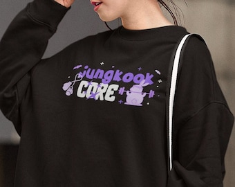 May include: Black sweatshirt with a purple graphic that says "jungkook CORE" with a cartoon character holding a dumbbell.