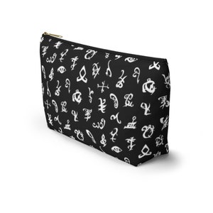 May include: Black zippered makeup bag with a white pattern of runes and symbols.