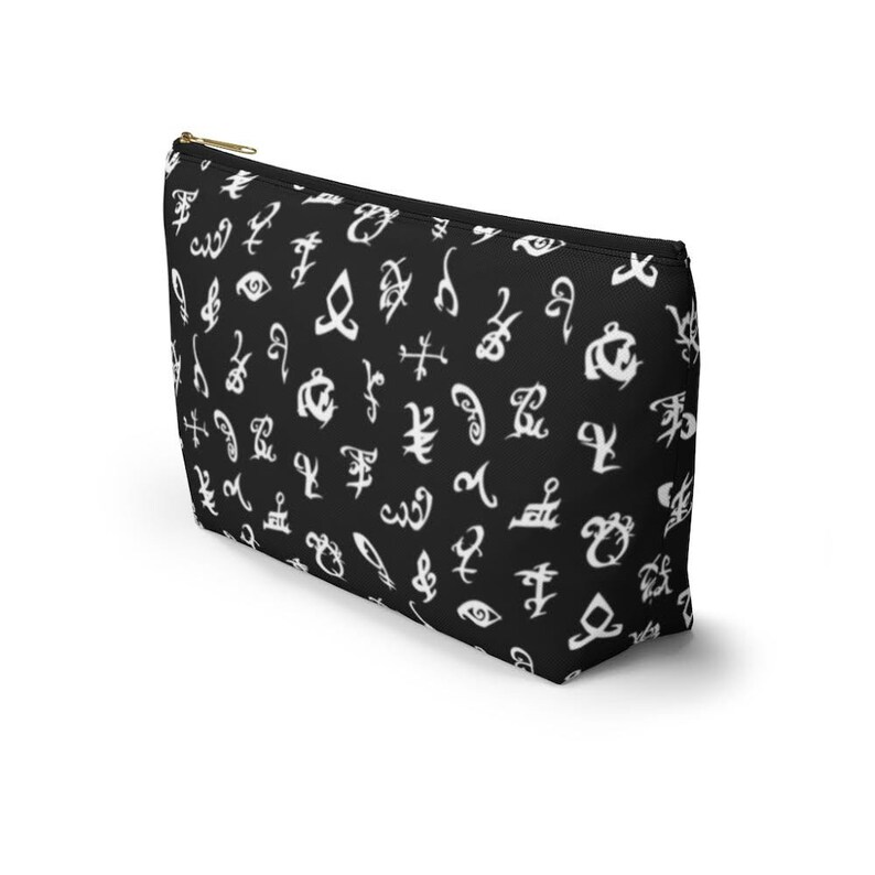 May include: Black zippered makeup bag with a white pattern of runes and symbols.