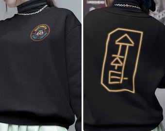 May include: Black sweatshirt with a circular logo on the front that says "Suchwita Chat + Drinks" and a gold outline of a symbol on the back.