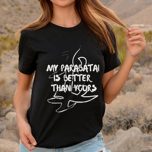 May include: Black t-shirt with white text that reads "My parabatai is better than yours" and a stylized drawing of a rune.