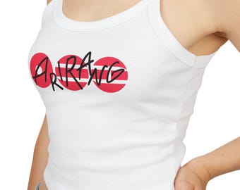 May include: White tank top with thin straps. The top features the word "ARAWG" in black script, overlaid on three red circles with horizontal white stripes. The garment is made of a soft, likely cotton material.