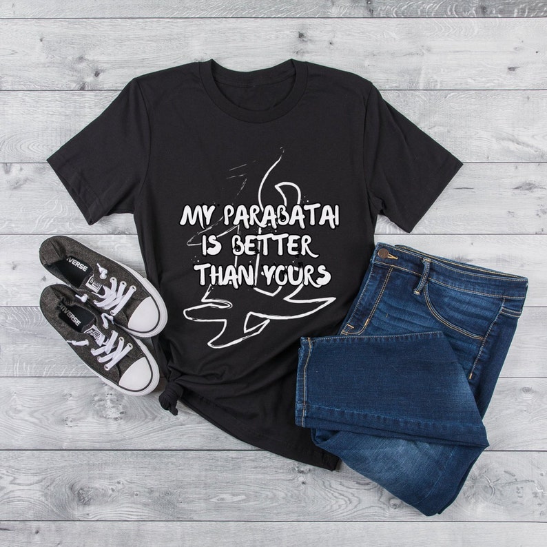 May include: Black t-shirt with white text that reads "My parabatai is better than yours". The shirt is styled with blue jeans and black sneakers.