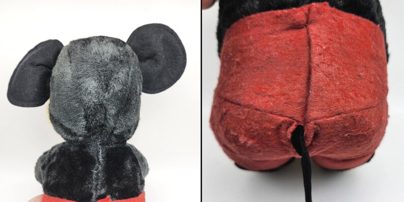 May include: Vintage Mickey Mouse plush toy, featuring black fur, large round ears, and red shorts. The plush has a black tail and is in a seated position. The toy's fur shows signs of wear.