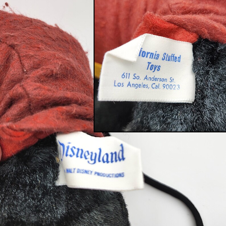 May include: Close-up of a vintage plush toy with a red head and black body. The toy has two tags, one reading "fornia Stuffed Toys" and the other "Disneyland Walt Disney Productions". The tags provide the address of the manufacturer.