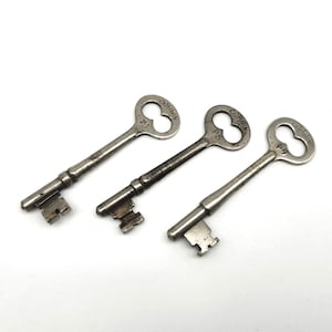 May include: Three antique metal keys with the word "CORBIN" stamped on the key heads. The keys are silver-toned and have a worn appearance. Each key has a different number: F1, P5, and P9.