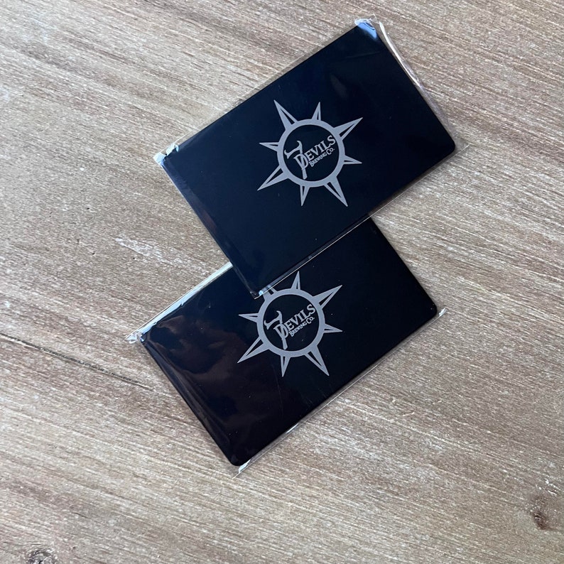 Luxury engraved stainless steel business card in black finish.